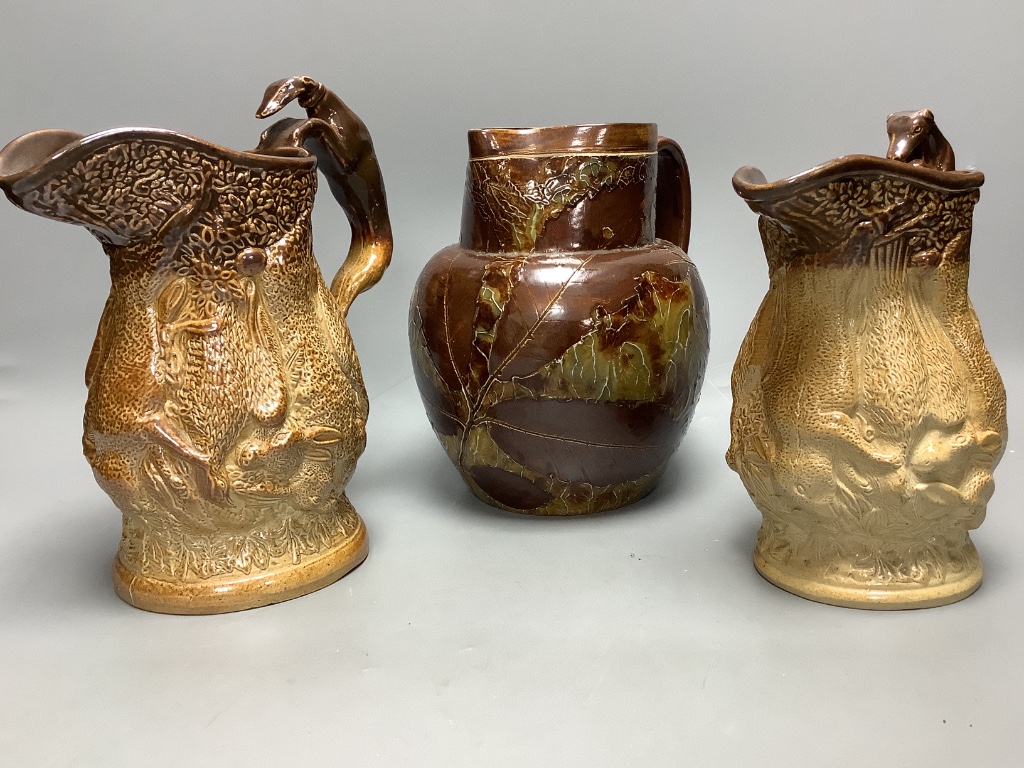 Two 19th century hunting related stoneware jugs and a Doulton Lambeth Autumn leaves stoneware jug, tallest 21cm